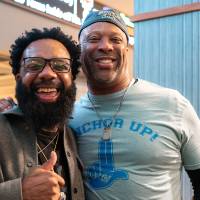 Two gentlemen at event smiling for camera